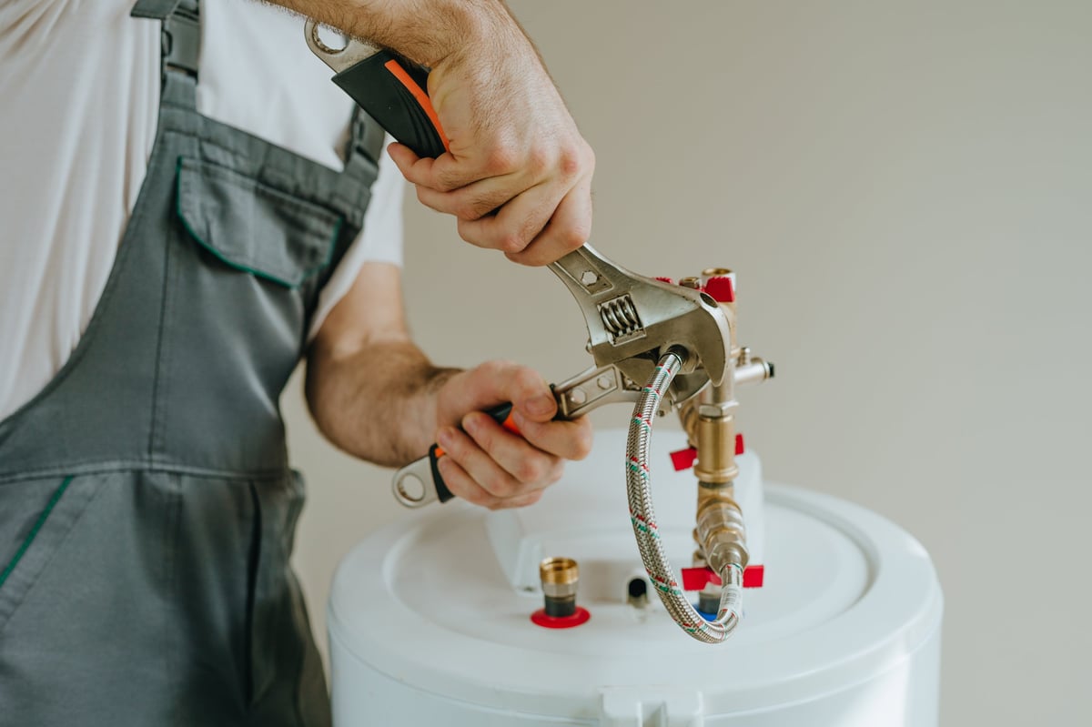 Licensed technician repairing a water heater in GTA Ontario